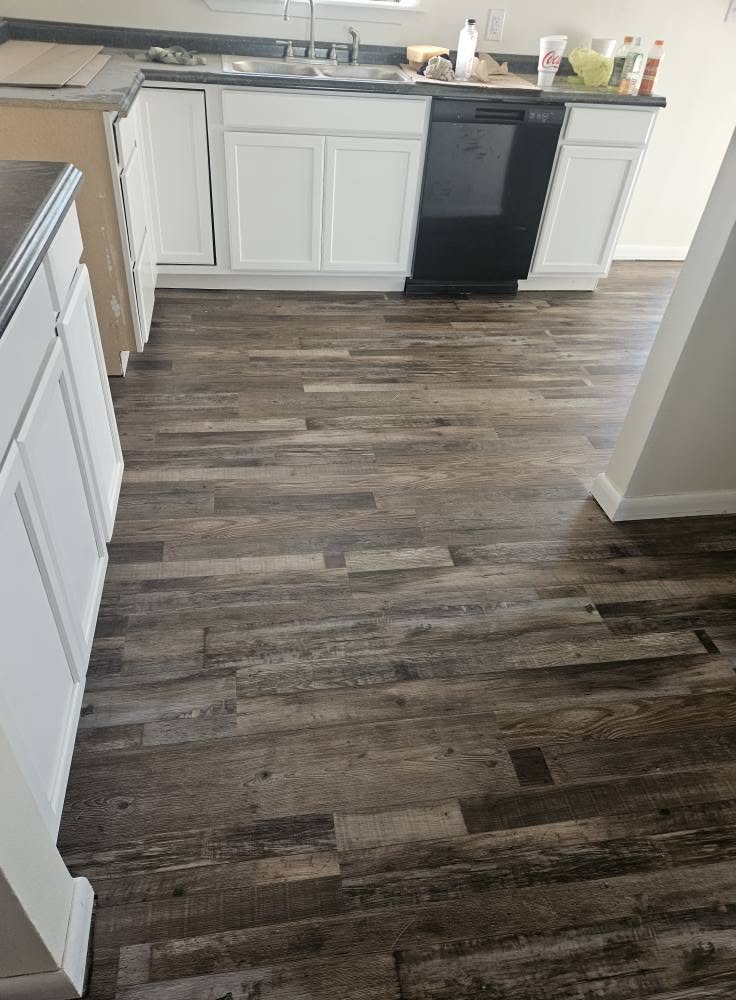 Luxury vinyl plank flooring installation in a custom kitchen by Floor Masters of Acadiana.
